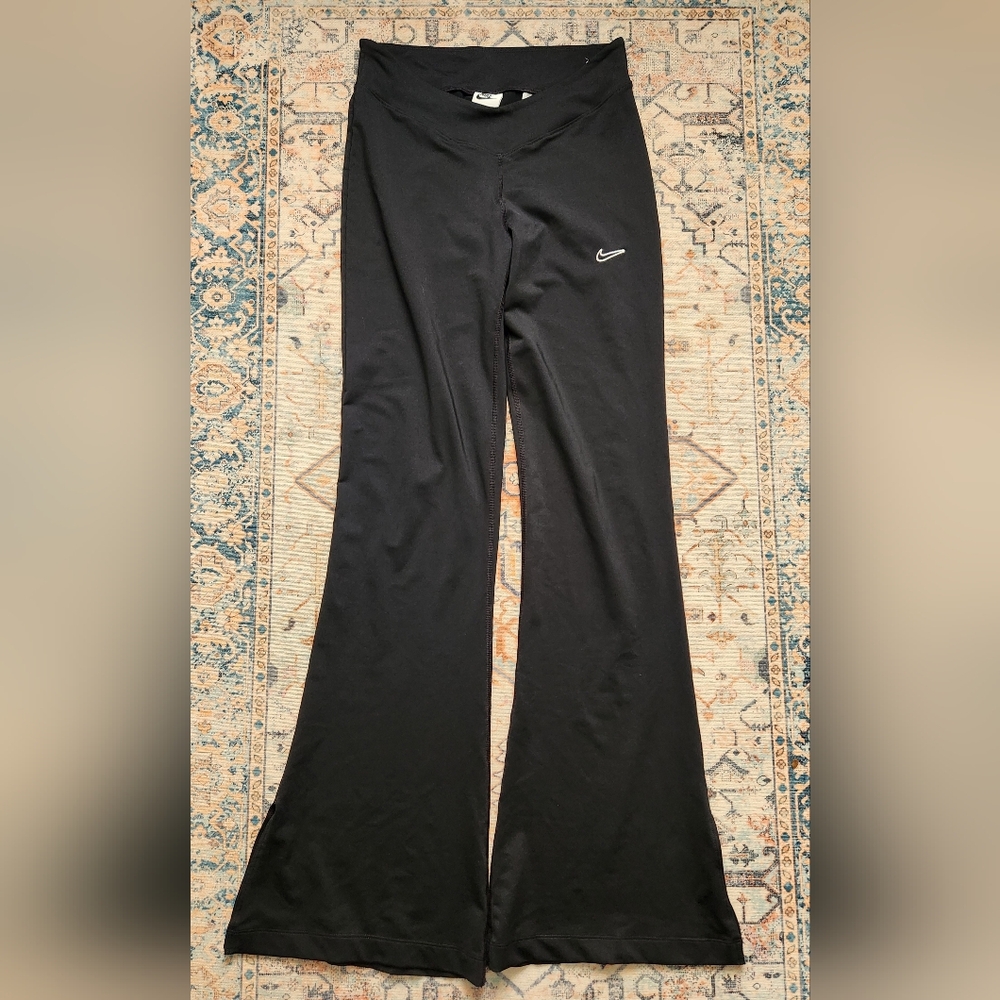 Nike Women's Sportswear Team High-Rise Flare Pants in black. Size M